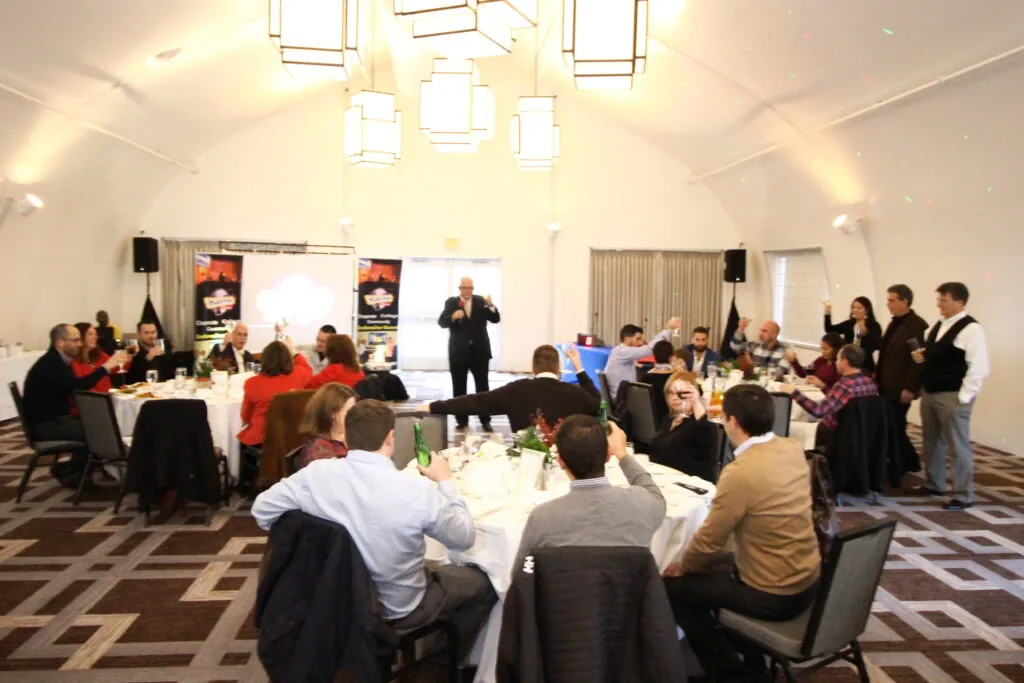 Full banquet room of employees at a company holiday party game show