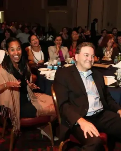 Icahn School of Medicine faculty laughing during a hosted trivia game show in NYC